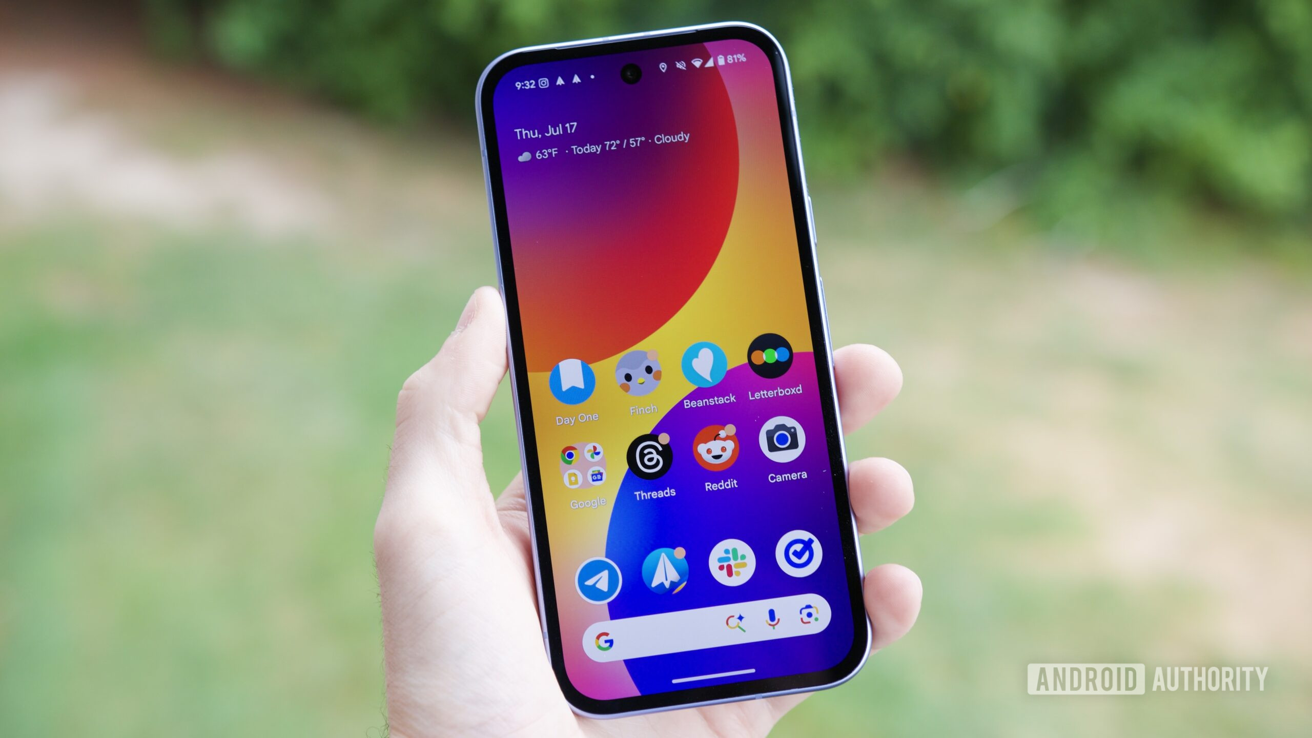google pixel 9a home screen hero feature Someone holding a Google Pixel 9a with its screen on.